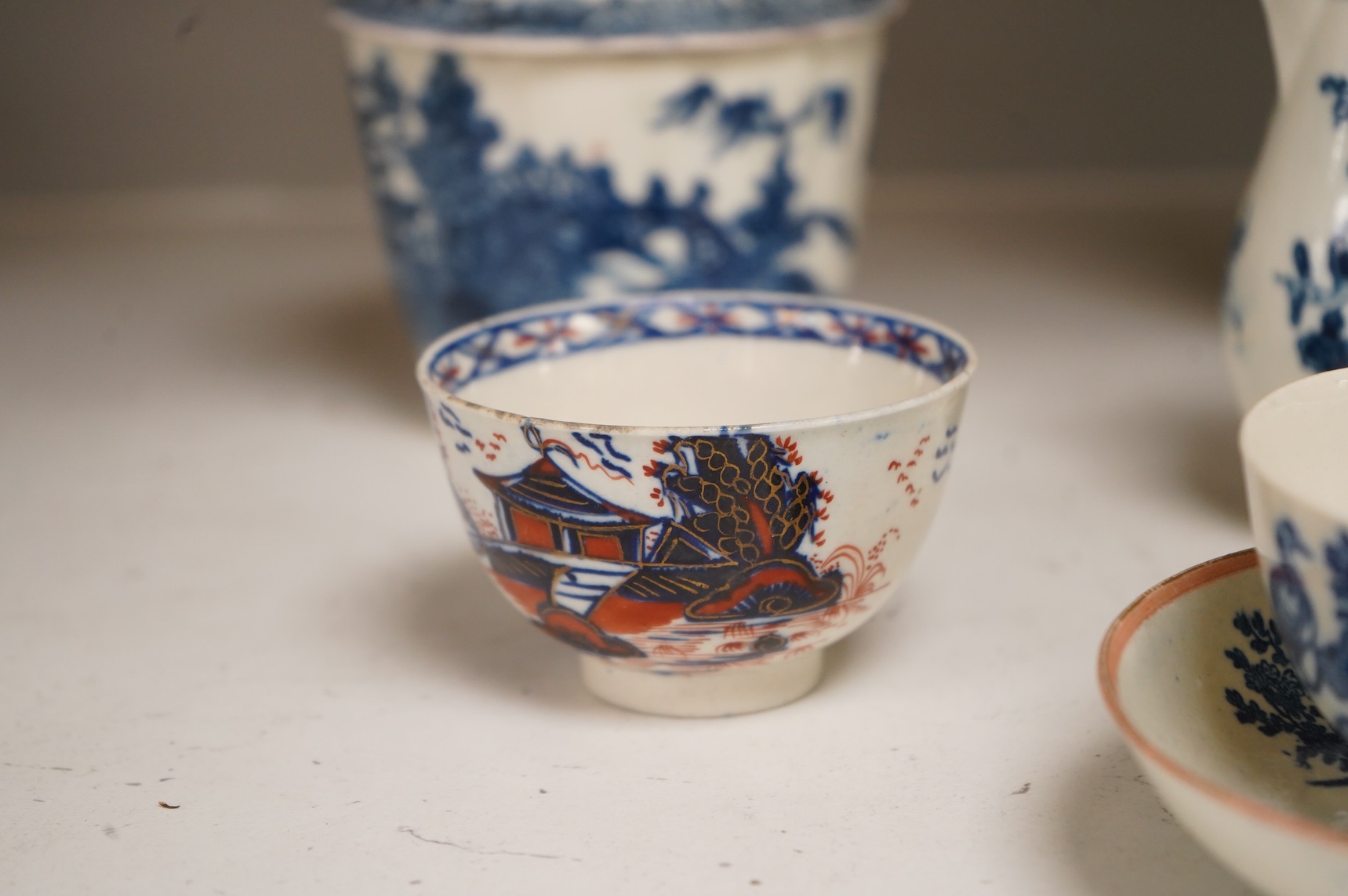 A collection of late 18th century Worcester, Caughley and Liverpool blue and white tea wares to include tea bowls and saucers, jug, suger basin and cover and two dishes etc, largest 23cm in diameter